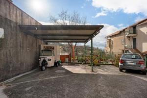 a golf cart parked under a cover in a parking lot at Silvana's House in Agerola