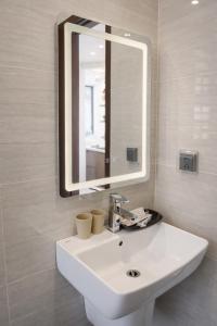 a bathroom with a white sink and a mirror at V3K03 Sonasea Vân Đồn in Thâm Câu +10 photos