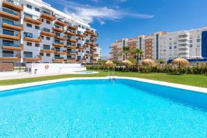 a swimming pool in front of a building at Adhara - 034 in Torre del Mar
