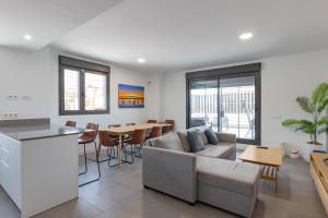 a living room with a couch and a table at Adhara - 034 in Torre del Mar