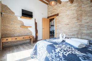 a bedroom with a bed and a brick wall at Casa rural Maño in Deltebre +19 photos