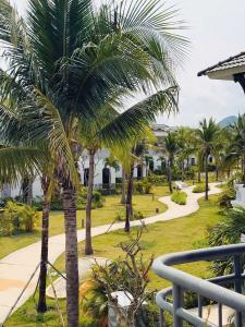 a view of a park with palm trees and a walkway at V3K03 Sonasea Vân Đồn in Thâm Câu