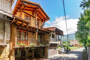 an old house with balconies on a street at Casa El Campano in Ontaneda