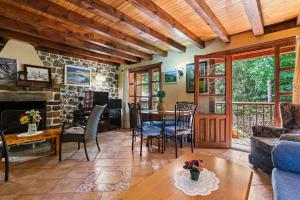 a living room with a table and a fireplace at Casa El Campano in Ontaneda
