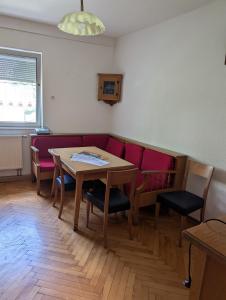 a living room with a table and a red couch at Backstubencafe Beck in Ansbach +6 photos