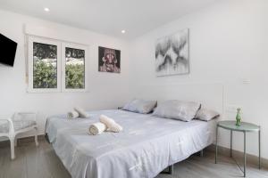 a white bedroom with a bed with pillows on it at Finca El Porvenir in El Gastor +27 photos