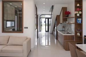 a living room with a couch and a kitchen at V3K03 Sonasea Vân Đồn in Thâm Câu