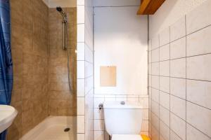 a bathroom with a toilet and a shower and a sink at Les Bouquetins A in La Rosière