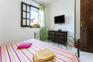 a bedroom with a bed with two towels on it at Casa Vacanze Villa Carola in Quartu SantʼElena