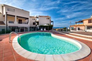 a swimming pool in the middle of a house at Gio's Apartment in Castelsardo