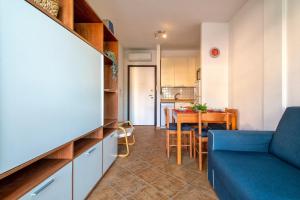 a living room with a blue couch and a table at Gio's Apartment in Castelsardo