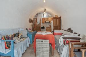 a living room with a couch and a table at Palatino in Astypalaia