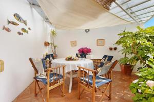 a dining room with a white table and chairs at Casa da Ria 78 - Family House in Torreira +29 photos