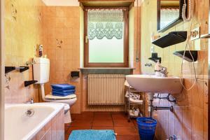 a bathroom with a sink and a toilet and a tub at Pension Sonia App 103 in Funes