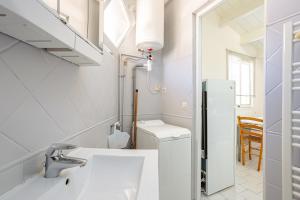 a bathroom with a sink and a toilet at Chambres d’hôtes Chantal Hereaudeau in Ars-en-Ré +38 photos