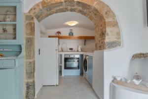 a kitchen with an archway in a house at Palatino in Astypalaia +34 photos