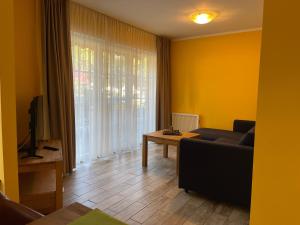 a living room with a couch and a table at Ferienhaus Specht in Zossen