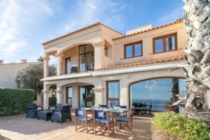 a house with a patio with a table and chairs at Almela's in Santa Pola