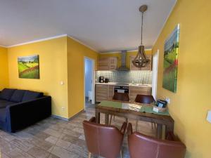 a kitchen and living room with a table and a couch at Ferienhaus Specht in Zossen