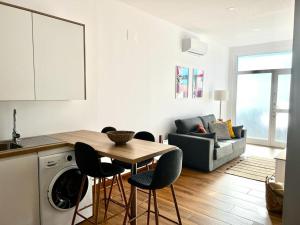 a kitchen and living room with a table and chairs at Jasmine L7 in Armeñime