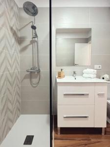 a bathroom with a shower and a white sink at Jasmine L7 in Armeñime
