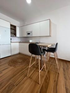 a kitchen with a table and chairs in a room at Jasmine L7 in Armeñime +8 photos