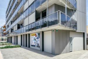 an office building with a balcony on the side of it at Rostella Apartment in Roses
