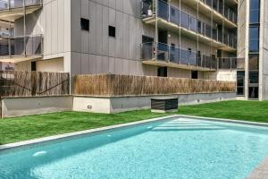 an empty swimming pool in front of an apartment building at Rostella Apartment in Roses