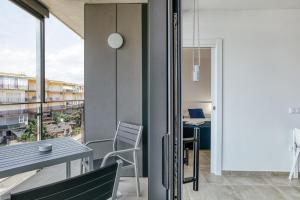an apartment with a balcony with a table and chairs at Rostella Apartment in Roses