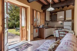 a kitchen and living room with a large window at Agriturismo Il Ponte - Frantoio in Vicchio