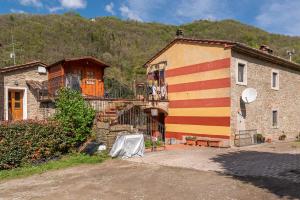 a building with red and yellow stripes on it at Agriturismo Il Ponte - Frantoio in Vicchio