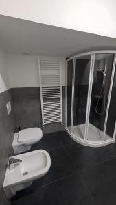 a bathroom with a white sink and a toilet at Casa Nicla in Colico
