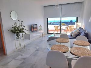 a living room with a glass table and chairs at Paraíso Azul in Nerja
