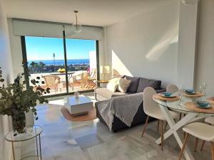 a living room with a couch and a table at Paraíso Azul in Nerja
