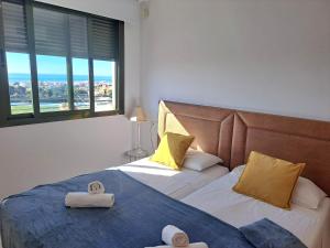a bedroom with two beds with towels on them at Paraíso Azul in Nerja +34 photos