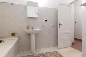 a white bathroom with a sink and a shower at Bellavita and pool in Brindisi +24 photos