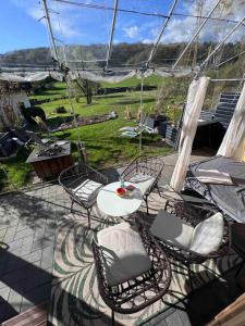 a patio with a table and chairs and a view of a field at Eifelsuiten - Private Spa & Family Hideaway - Kerpen Loogh in Kerpen