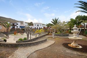 a park with a fountain and trees and buildings at Casa Marrero in La Guancha
