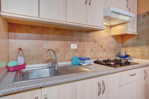 a kitchen with a sink and a stove at Casa Marrero in La Guancha +19 photos