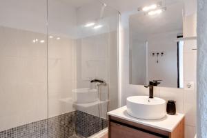 a white bathroom with a sink and a shower at Can Espina in Islas Baleares +17 photos