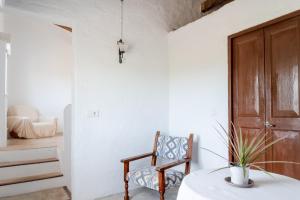 a room with a wooden door and a chair at Can Espina in Islas Baleares