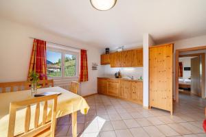 a kitchen with a table and a dining room at Gasserhof Ferienwohnung Edelrot in Caines