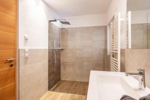 a bathroom with a shower and a sink at Reiterhof Apt Flora in San Genesio Atesino