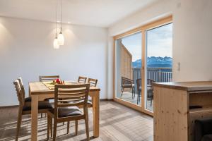 a kitchen and dining room with a table and chairs at Reiterhof Apt Flora in San Genesio Atesino