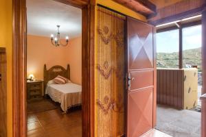 a bedroom with a bed and a sliding glass door at Casa Chinamada in Las Lagunas