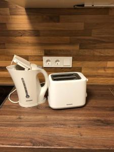 a white toaster sitting on top of a wooden floor at Ferienhaus Kiara in Westerhausen