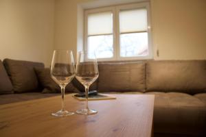 two wine glasses sitting on top of a wooden table at Ferienhaus Kiara in Westerhausen