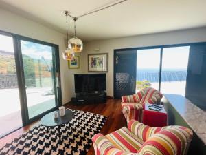 a living room with two couches and a table at Villa Camacho xxvii in Arco da Calheta