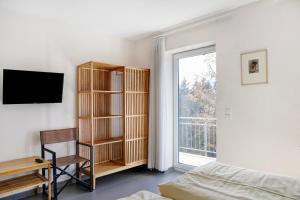 a bedroom with a book shelf and a window at Ferienwohnung Tannenblick 6-2 in Oberhof