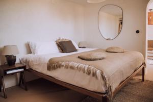 a bedroom with a large bed with a mirror on the wall at The June Boutique in Benissa +37 photos